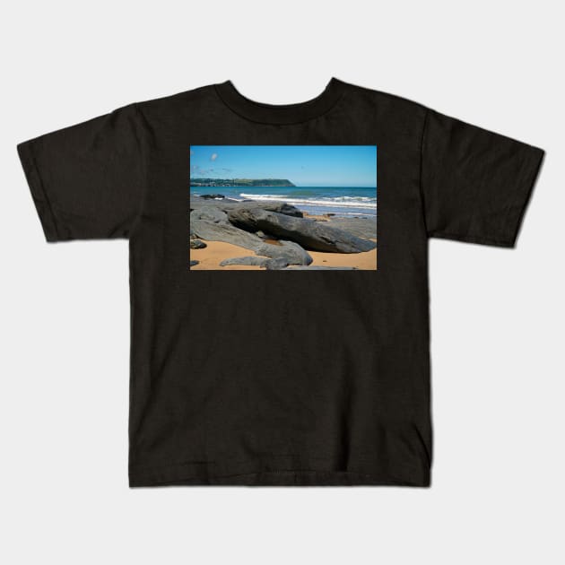 Coastal Scenery Of Large Rocks On Sandy Beach Kids T-Shirt by Harmony-Mind